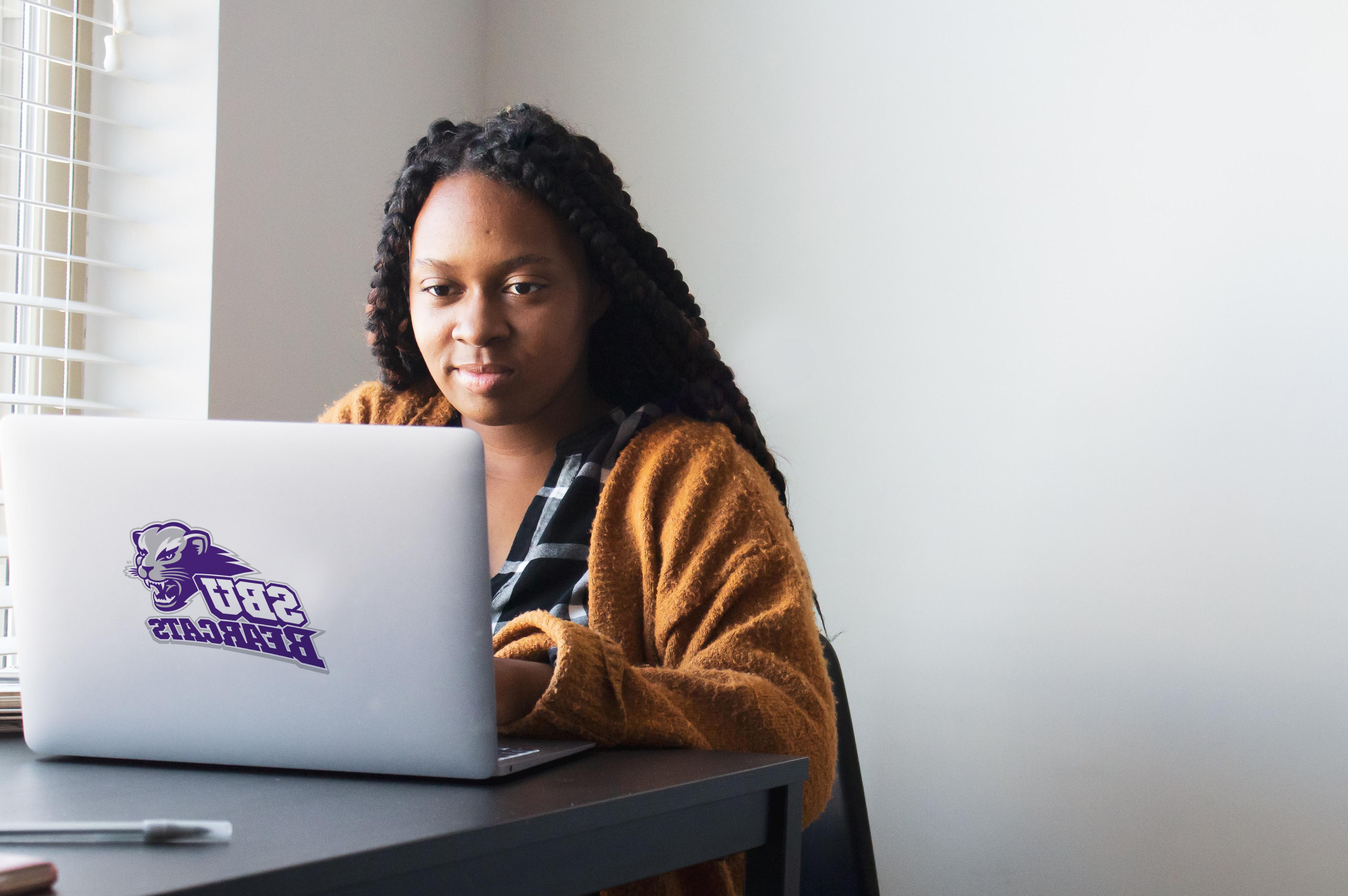 woman looking over her s.b.u worldwide coursework